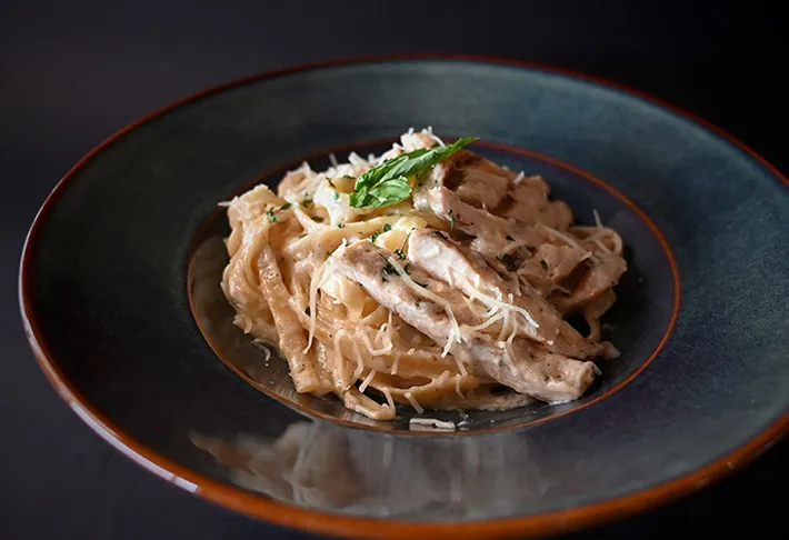 Delicious Grilled Chicken Alfredo dish at Tonic Kitchen + Bar in Calgary, AB